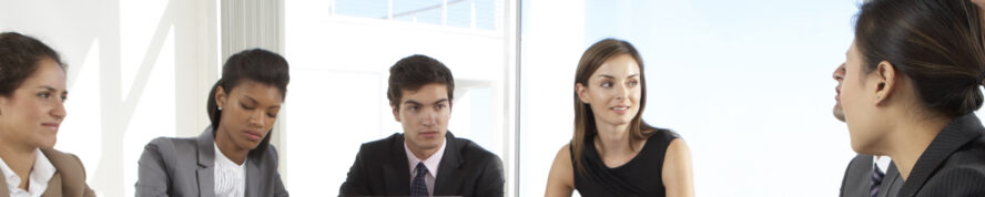 Group of people sitting around a table in discussion.